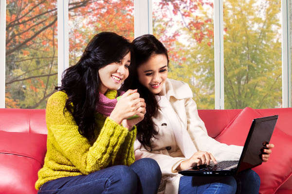 woman and daughter wearing layers for heating at home