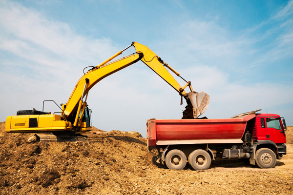 image of construction trucks that require fuel