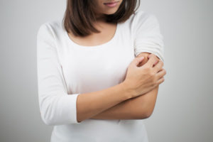 image of homeowner itching skin from dry indoor air in winter