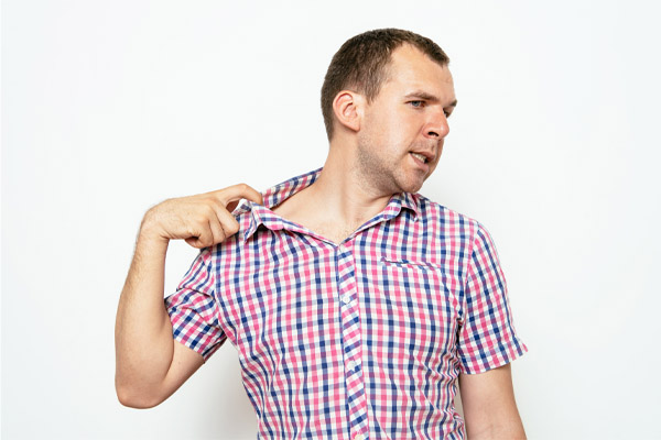 image of a homeowner feeling hot and humid due to oversized air conditioner