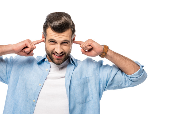 image of a homeowner plugging ears due to loud boiler