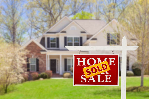 image of a sold sign in front of a house that uses propane heat