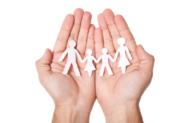 image of family paper cutout in hands depicting home heating oil safety