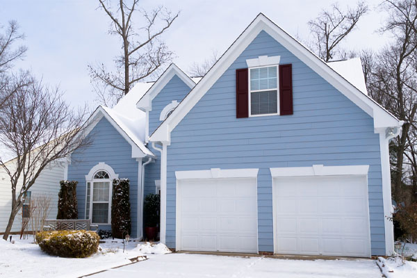 image of a house in winter that uses heating oil