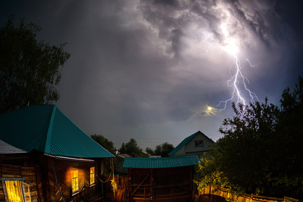 house with power at night during a power outage and backup generator