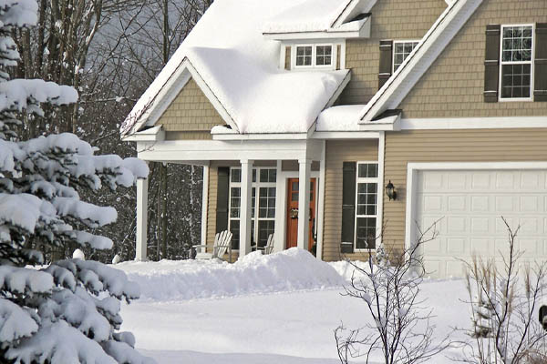 house in snow depicting home heating in winter