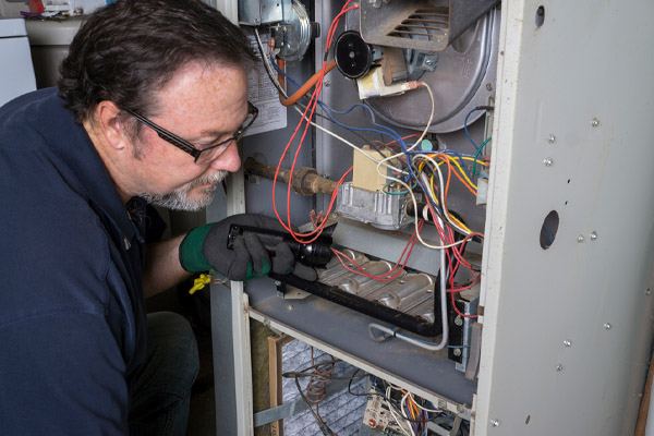 image of an hvac contractor performing a furnace tune-up