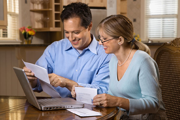 Smiling couple calculating home heating savings