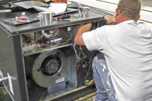 image of an hvac contractor performing air conditioner tune-up