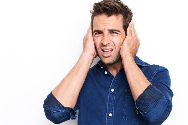 image of a man covering ears because air conditioner noises