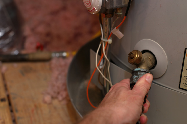 image of a plumber performing water heater flush