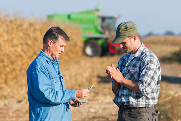 image of farmer paying predictable farm fuel delivery costs