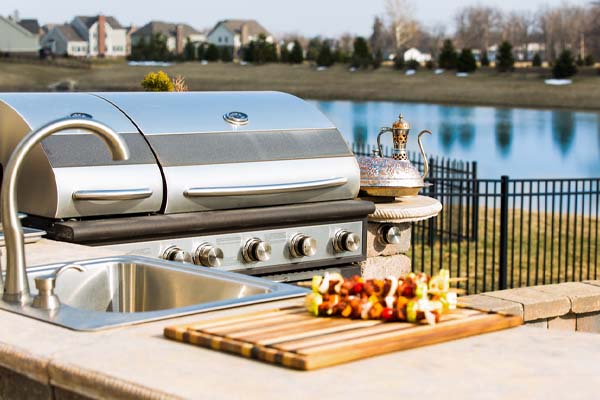 image of an outdoor kitchen with a propane grill