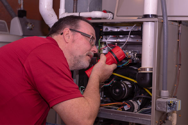 image of an hvac contractor performing a furnace repair