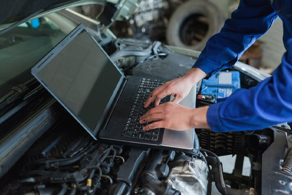 image of a mechanic maintaining fleet vehicles