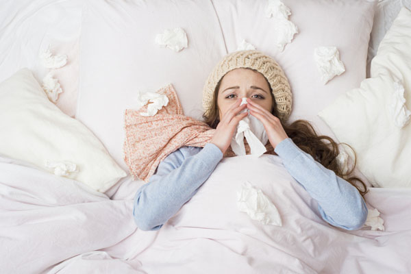 sick woman in bed due to indoor air pollution