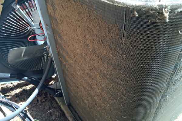 dirty coil fins on a home air conditioner compressor