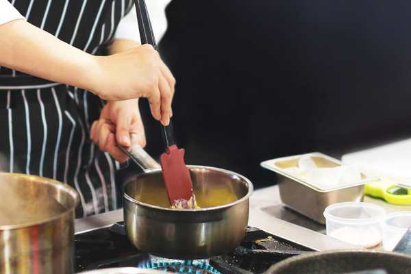 image of a homeowner cooking with a gas stove