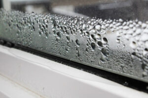 image of window condensation in winter due to air leakage impacting home heating efficiency