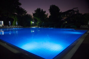 image of a pool at night depicting propane pool heating