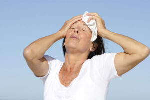 woman feeling hot because ac unit isn't blowing cool air